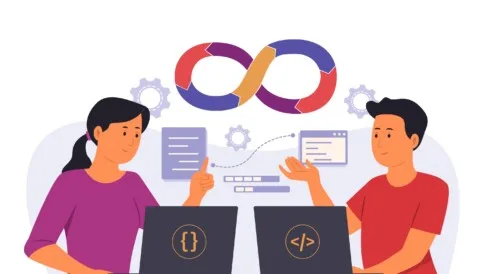 a couple of people sitting at a table with laptops