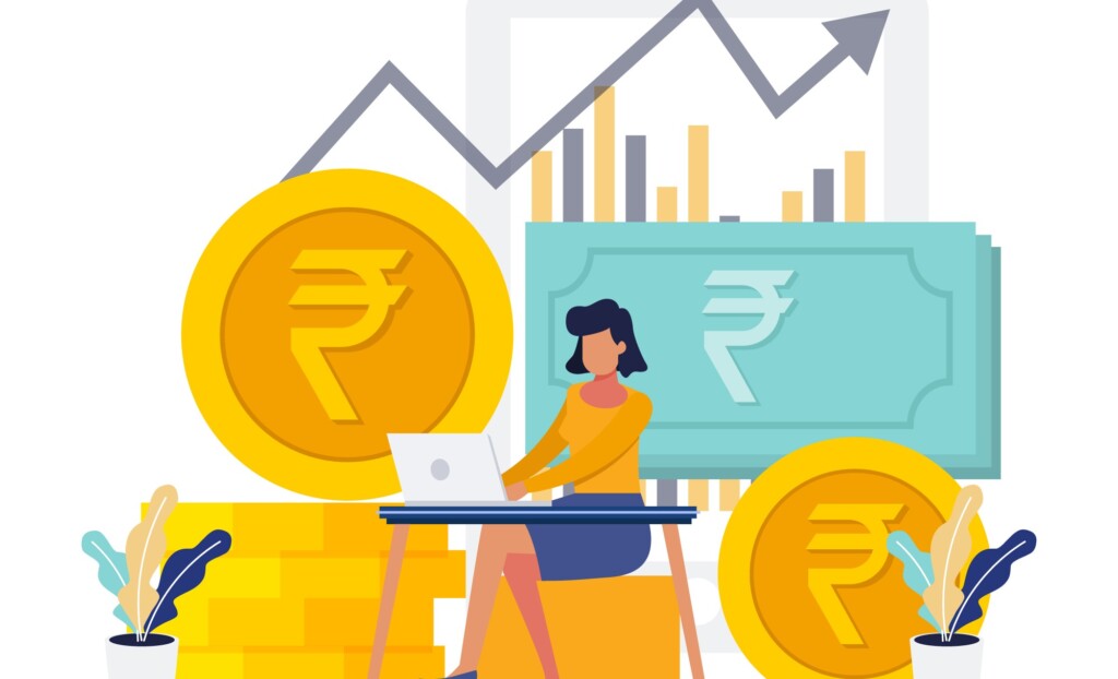 a woman sitting at a desk with a laptop and coins